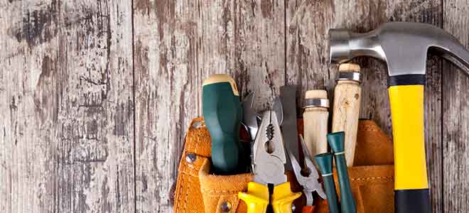 Photo of carpentry tools on a weathered wooden surface, used as a maintenance blog header.