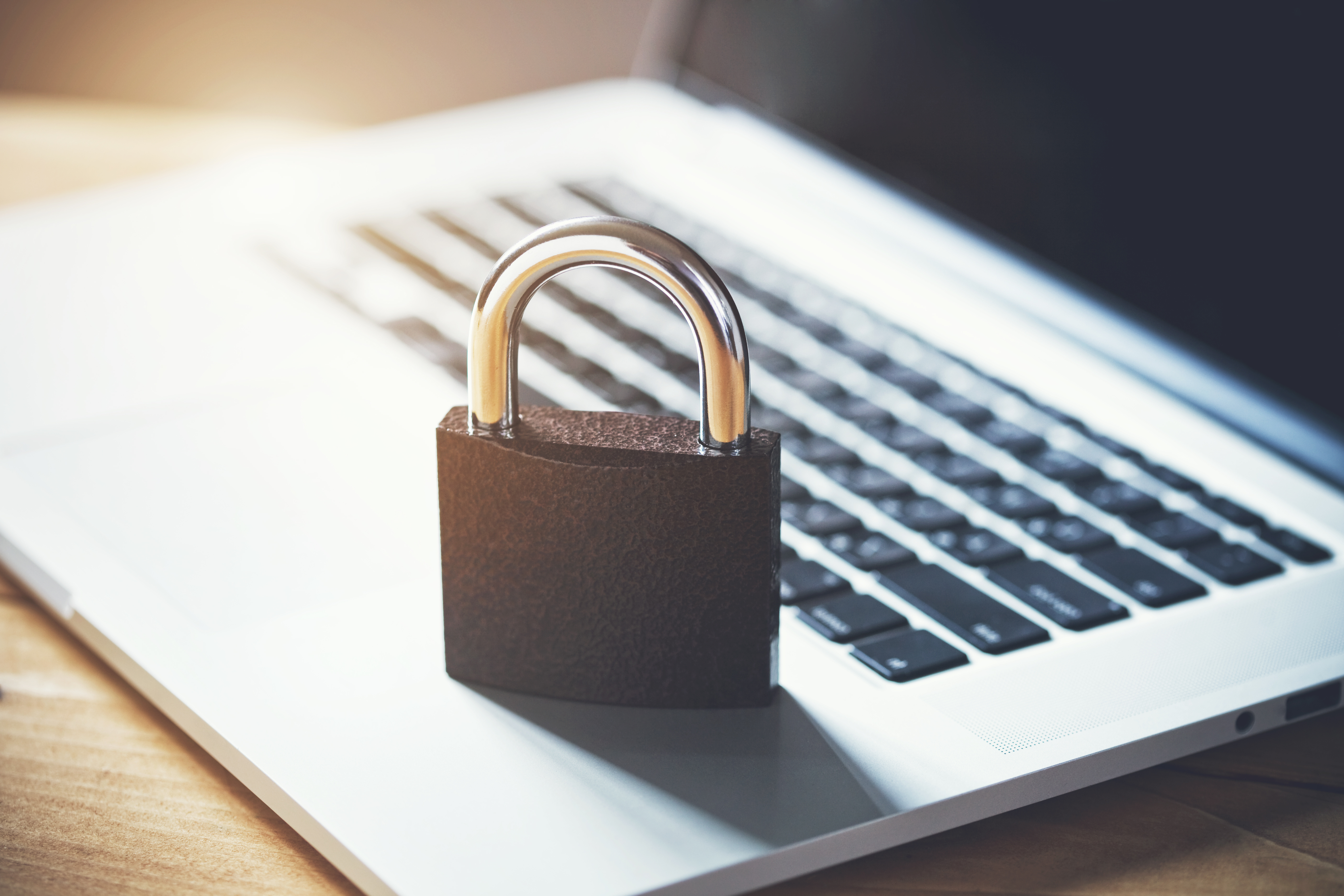 Photo of a padlock resting on a laptop keyboard, used as a data privacy blog header.