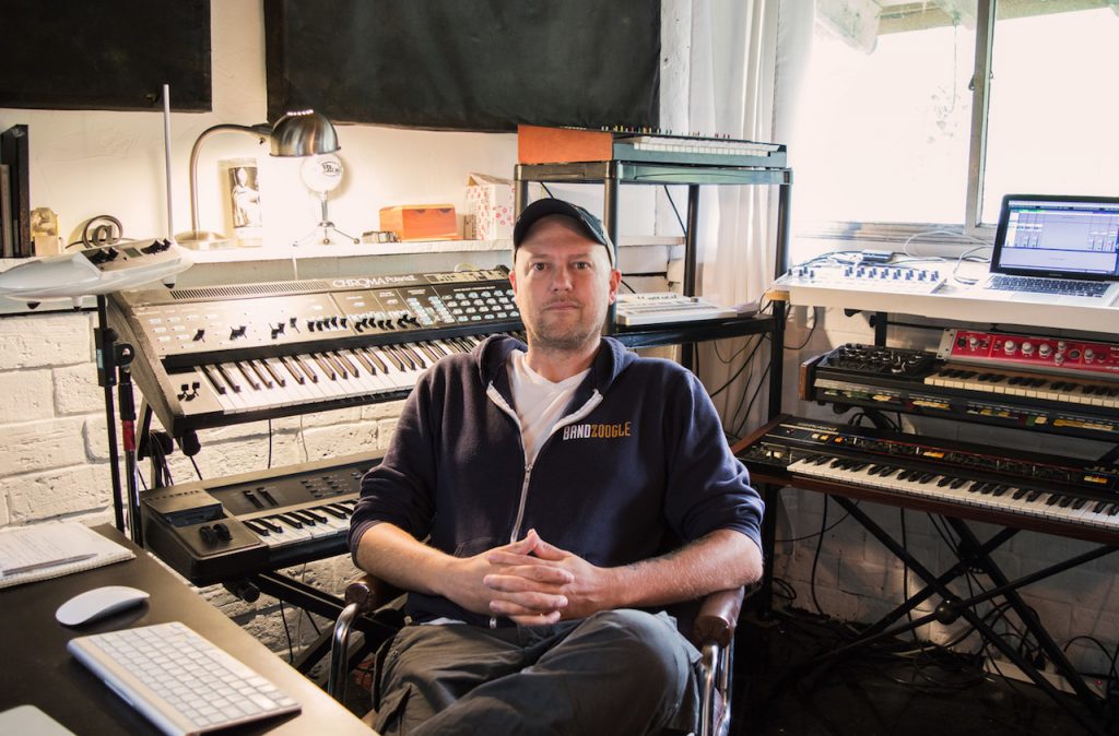 Bandzoogle's Technical Support Manager, Adam, sits in his at-home production studio.