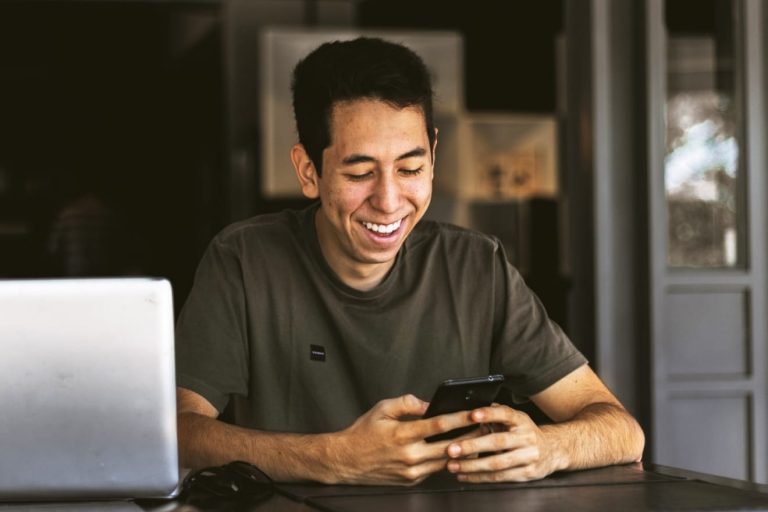 young smiling man on phone